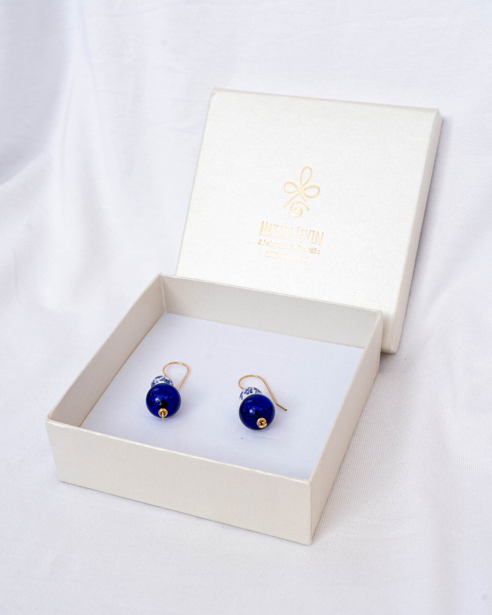 Dutch ceramic bead earrings, and a Greek blue eye bead - Image 1